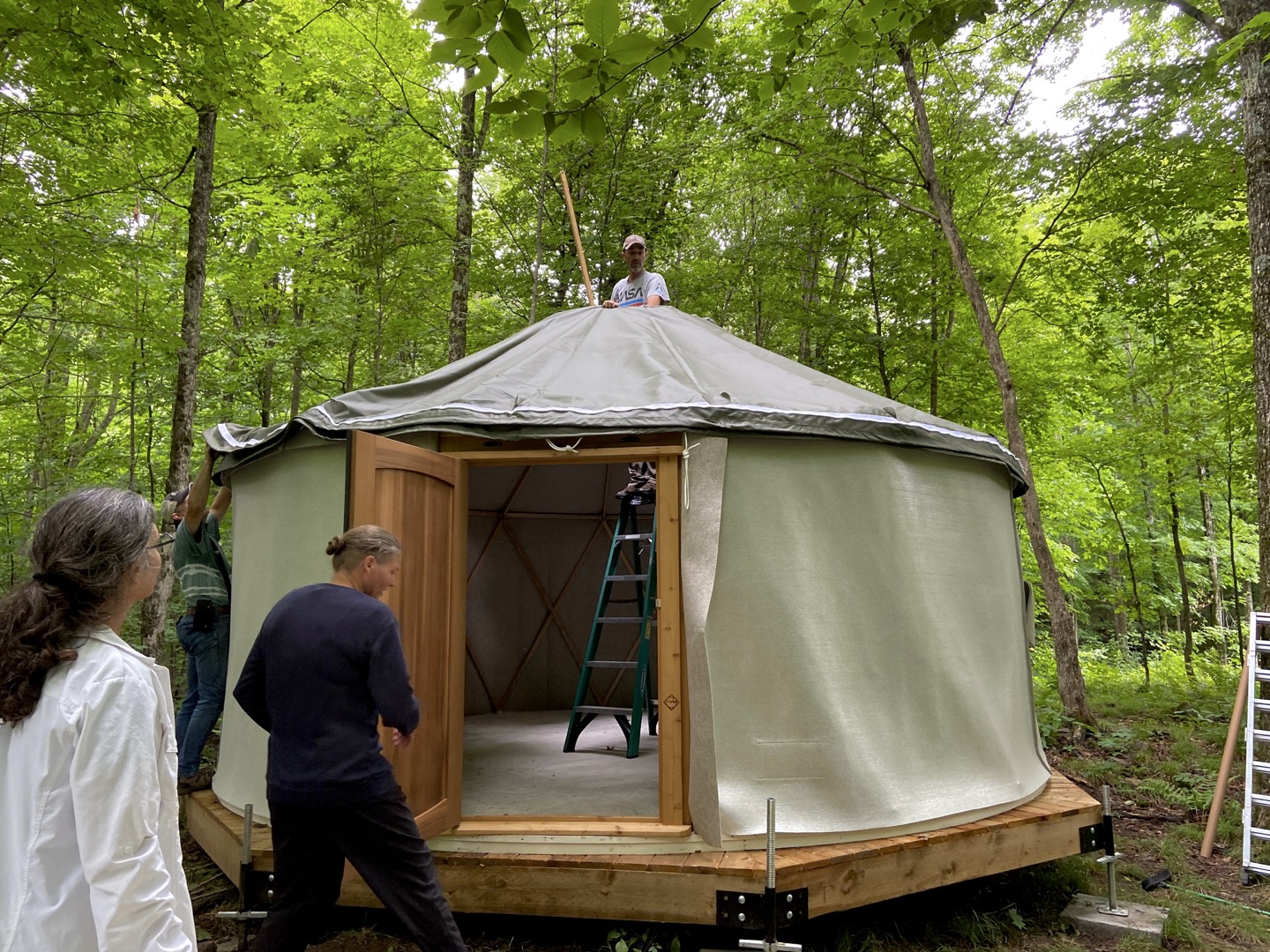 Draping felt and canvas over the roof and walls with the stick supplied in the build kit